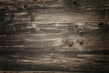 Rustic dark wooden planks background with vivid texture and vignette lighting