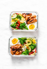 Rice, stewed vegetables, egg, teriyaki chicken - healthy balanced lunch box on a light background, top view. Home food for office concept. Copy space
