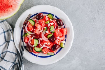 Fresh summer watermelon salad with feta cheese, cucumbers, olives and red onions