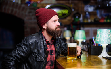 Pub great place to dine drink and have fun. Hipster relaxing at pub. Man with beard spend leisure in dark pub. Brutal hipster relaxing. Guy bearded man sit at bar counter in pub. Weekend lifestyle