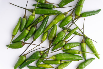 Fototapeta premium Green Bird's eye chili ,Thai Chili pepper ,bird chili pepper nature isolate on white background. Selective focus and crop fragment