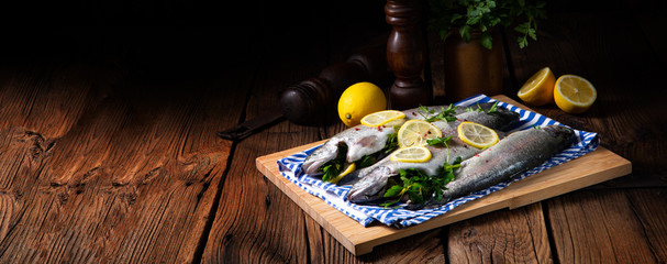 fresh trout with lemon and different herbs