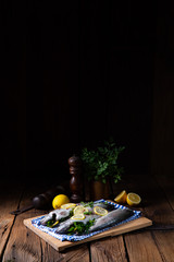 Fototapeta na wymiar fresh trout with lemon and different herbs
