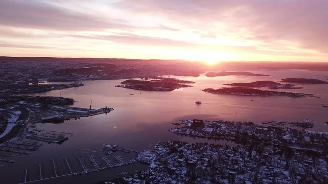Approaching aerial shot towards a boat in Oslofjord at the sunset in Oslo, Norway