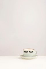 Eyelashes coffee cup. Wake-up concept