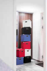 Stacked boxes in various colors in a bright room