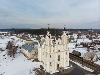 Old catholic church in Belarusian village. White church. All in the snow. View from above. View from the sky. The photo was taken by drone, copter.