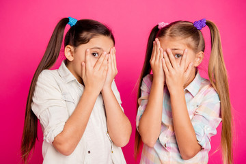 Close up photo two little age girls hands arms hide head palms show one eye full of fear wearing...