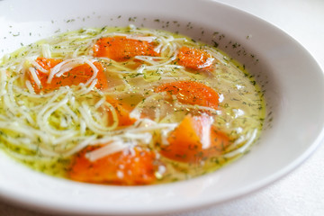 Chicken broth with carrot and dill. Traditional polish soup.