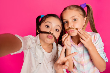 Close up photo two small little age she her girls moustache pretend make take summer camp selfies v-sign wearing casual jeans denim checkered plaid shirts isolated rose vibrant bright background