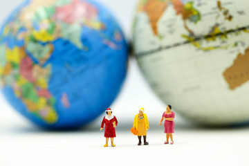 Miniature people : Group of Women Teamwork Happiness with world map using for concept of International women day.