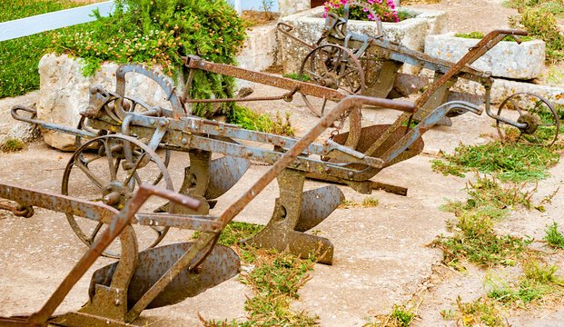Ancient iron plows on a farm in the countryside of Puglia