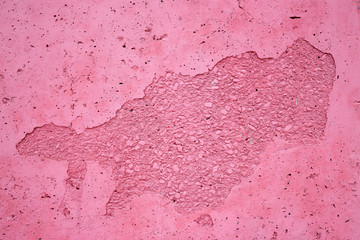 Concrete wall texture. Uneven peeling surface painted pink. Perfect for background and design.