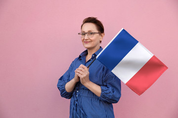 France flag. Woman holding French flag. Nice portrait of middle aged lady 40 50 years old holding a...