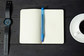 Time management concept. Note pad, cup of coffee and mechanical watch, top view