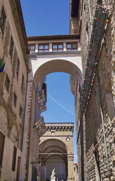 View of Vasari Corridor and loggia dei Lanzi from Neri street, Florence, Italy