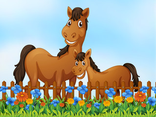 Obraz na płótnie Canvas Horse family at flower garden