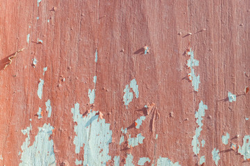 Cracked wall with old layers of paint on the wooden. 