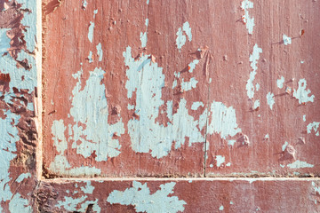 Cracked wall with old layers of paint on the wooden. 