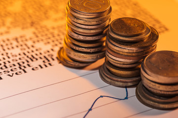 selective focus of coins stacks on business document with graphs
