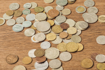 selective focus of different silver and golden coins on wooden background