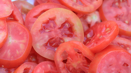 Round cut red tomatoes closeup