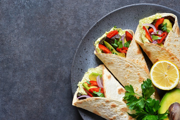 Classic Mexican cuisine. Tacos with beef, avocado, chili and tomatoes. View from above.