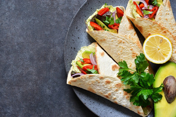 Classic Mexican cuisine. Tacos with beef, avocado, chili and tomatoes. View from above.