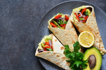 Classic Mexican cuisine. Tacos with beef, avocado, chili and tomatoes. View from above.