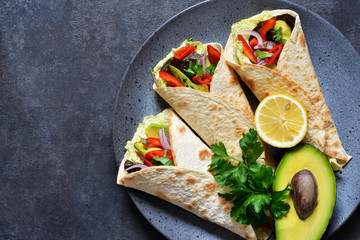 Classic Mexican cuisine. Tacos with beef, avocado, chili and tomatoes. View from above.