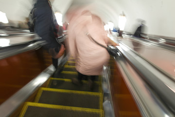 Blurred photo of people on the escalator in the subway