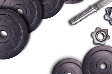 Dumbbells on carbon background. Dumbbells and weights are lying on the floor in the gym. Barbell set and gym equipment. Metal loads in the fitness club.