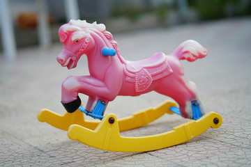 beautiful vintage rocking horse in pastel colors with the passing of time