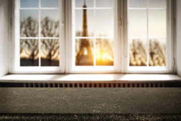 Table background of free space for your decoration. White wooden window space. Sunset time and Paris city landscape. 