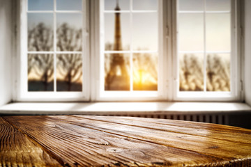 Table background of free space for your decoration. White wooden window space. Sunset time and Paris city landscape. 