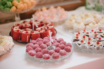 Variety of candies, cakes and cupcakes at the candy bar