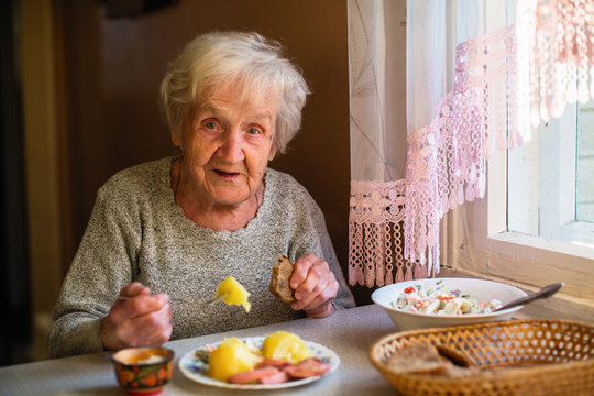 An elderly woman portrait dines in his home.