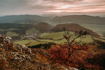 Colorful autumn landscape in the mountain village. Foggy morning in the Carpathian mountains. 