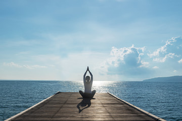 Healthy woman lifestyle balanced practicing meditate and zen energy yoga on outdoors the bridge in morning. Healthy life Concept..