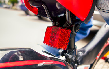 Closeup of red bicycle rear reflector.
