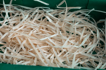 Wood shavings in the green paper box