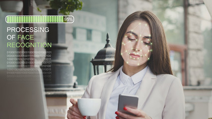 Woman using biometric facial verification on smartphone