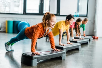 Poster Children doing plank exercise with step platforms © LIGHTFIELD STUDIOS