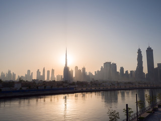 Fototapeta na wymiar Panorama of the city of Dubai early in the morning at sunrise with a bridge over the city channel Dubai Greek.