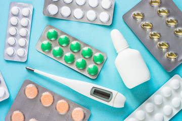 Tablets and medicines on a blue background.