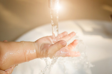 kid hand open for drinking tap water
