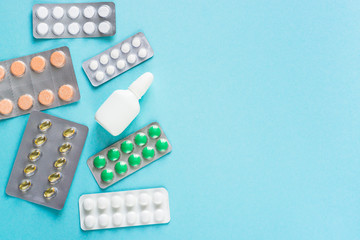 Tablets and medicines on a blue background.