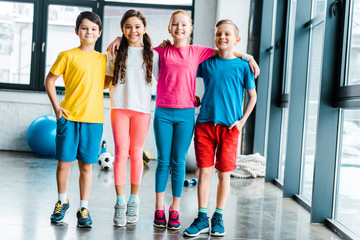 Obraz premium Preteen kids embracing after training in gym