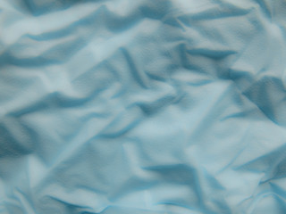 Creative idea for background. Soft blue crumpled paper
