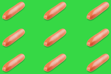 Horizontal rows of prepared long sausages on green background. Seamless pattern